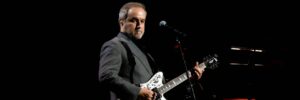 David Arnold performing on stage with the Royal Philharmonic Concert Orchestra at The Sound of 007 at the Royal Albert Hall.