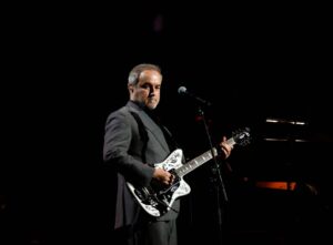 David Arnold performing on stage with the Royal Philharmonic Concert Orchestra at The Sound of 007 at the Royal Albert Hall.